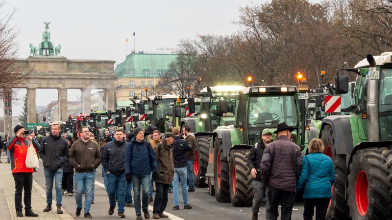 Berlin, Germany December 18. 2023 Farm tractors with the Brandenburg Gate in the background.